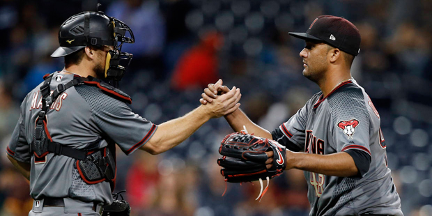 Arizona Diamondbacks catcher Jeff Mathis, left, celebrates with relief pitcher Randall Delgado afte...