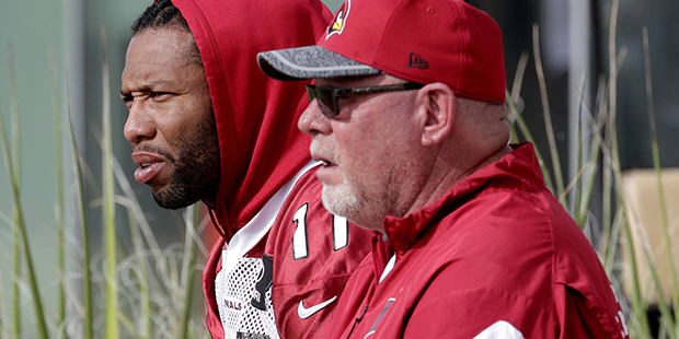 Arizona Cardinals head coach Bruce Arians and Larry Fitzgerald watch players during an NFL football...
