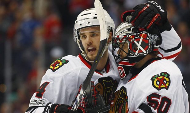 Chicago Blackhawks defenseman Niklas Hjalmarsson, left, of Sweden, congratulates goalie Corey Crawf...