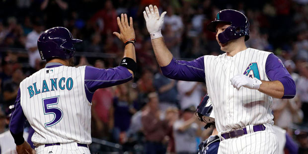 Arizona Diamondbacks' Chris Iannetta high fives teammate Gregor Blanco after hitting a two-run home...