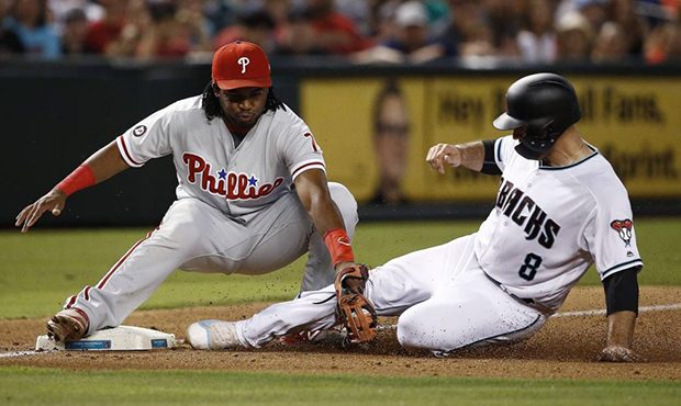 Arizona Diamondbacks' Chris Iannetta (8) is tagged out at third base by Philadelphia Phillies' Maik...