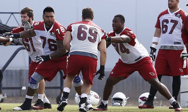 Arizona Cardinals offensive linemen D.J. Humphries (74), Mike Iupati (76) and Cole Toner (61) help ...