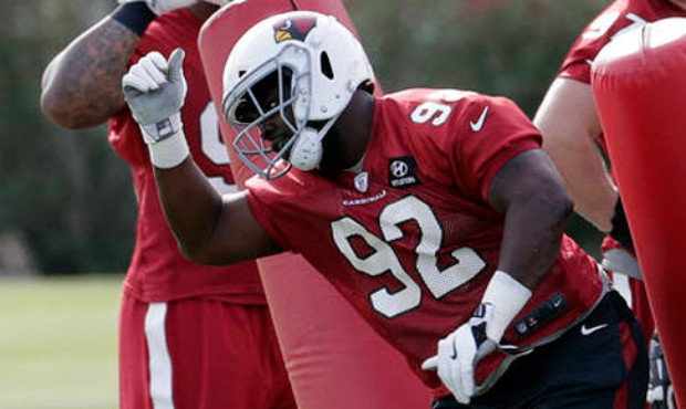 Arizona Cardinals' Frostee Rucker (92), Ed Stinson (91) and Pasoni Tahini (65) run drills during an...