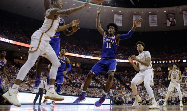 Texas guard Kerwin Roach Jr. (12) passes the ball as Kansas' Landen Lucas, left, and Josh Jackson (...
