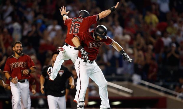 Arizona Diamondbacks' Daniel Descalso, right, celebrates his game-winning walk off single against t...