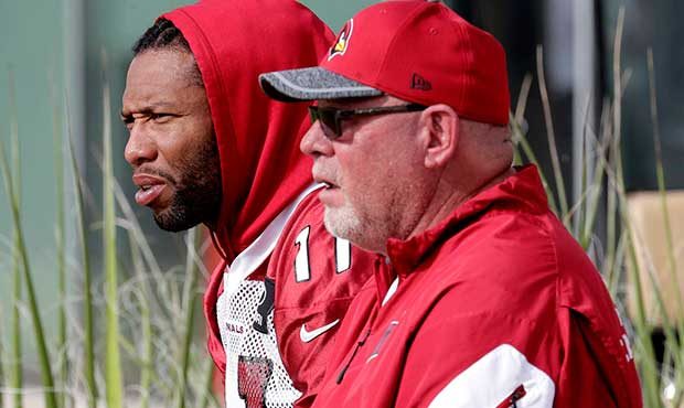 Arizona Cardinals head coach Bruce Arians and Larry Fitzgerald watch players during an NFL football...
