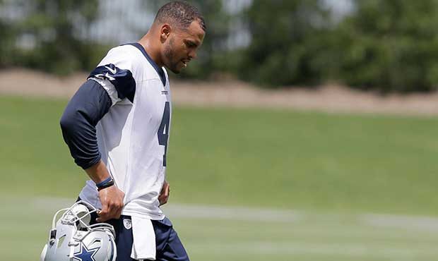 In this photo taken June 13, 2017, Dallas Cowboys quarterback Dak Prescott walks to the sideline du...