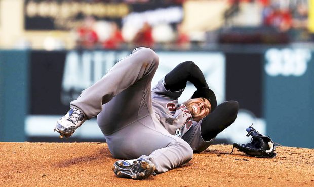 Arizona Diamondbacks pitcher Robbie Ray writhes in pain Friday, July 28, 2017, after getting hit on...