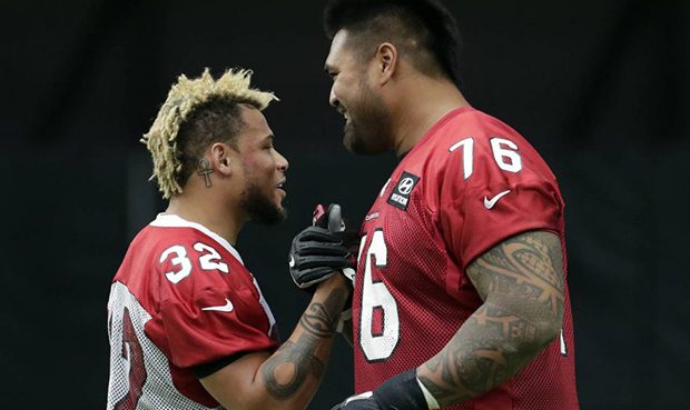 Arizona Cardinals free safety Tyrann Mathieu (32) and guard Mike Iupati (76) greet each other durin...