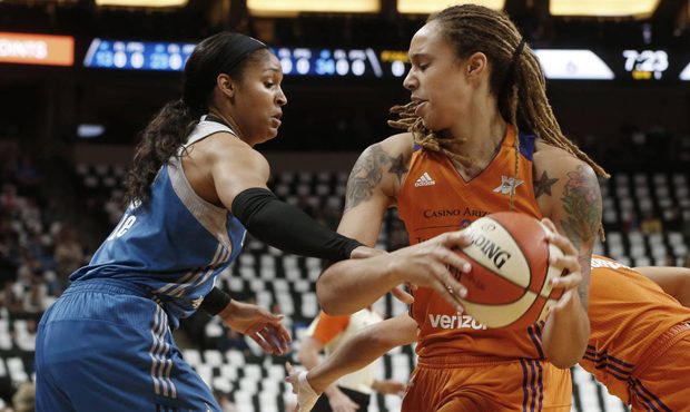 Phoenix Mercury's Brittney Griner, right, keeps the ball away as Minnesota Lynx's Maya Moore defend...