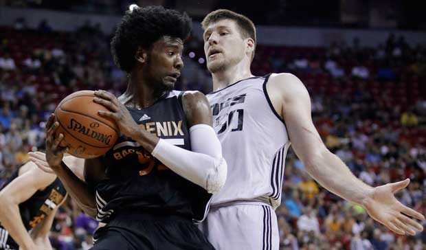 Phoenix Suns' Josh Jackson grabs a rebound next to Sacramento Kings' Jack Cooley during the first h...