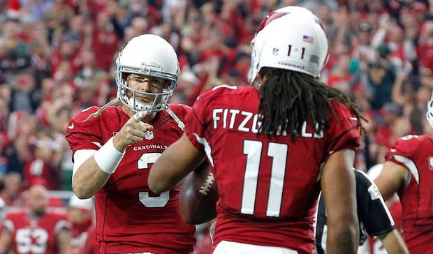 Arizona Cardinals quarterback Carson Palmer (3) points to wide receiver Larry Fitzgerald (11) after...
