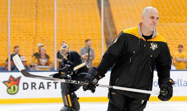 Pittsburgh Penguins' Phil Kessel, right, skates with assistant coach Rick Tocchet on the outdoor ho...