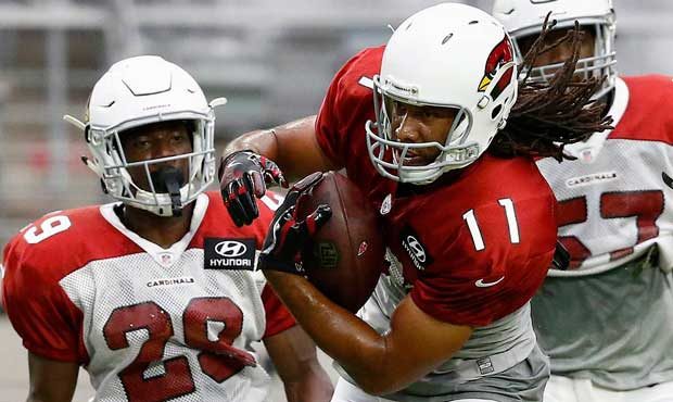 Arizona Cardinals receiver Larry Fitzgerald (11) makes a catch between defenders, including Ronald ...