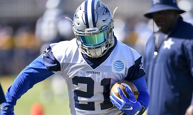 Dallas Cowboys running back Ezekiel Elliott runs a drill during NFL football training camp in Oxnar...