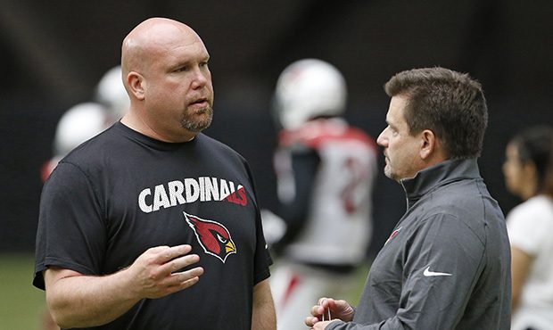 Arizona Cardinals president Michael Bidwill, right, talks with general manager Steve Keim during pr...