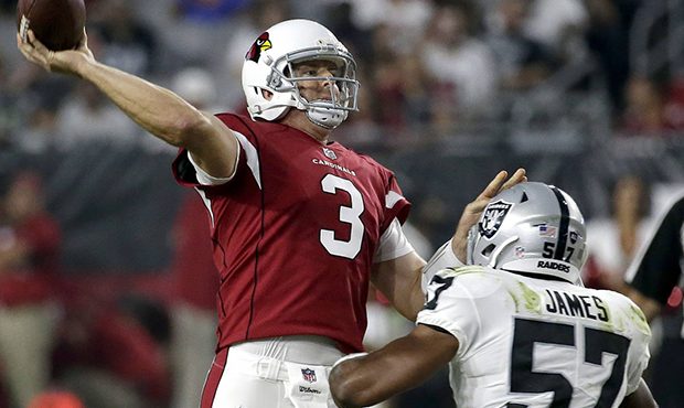 Arizona Cardinals quarterback Carson Palmer (3) throws under pressure from Oakland Raiders middle l...