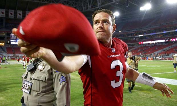 Arizona Cardinals quarterback Carson Palmer (3) tosses hit cap to fans after a preseason NFL footba...