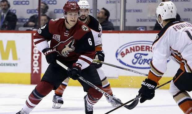 Arizona Coyotes defenseman Jakob Chychrun (6) drives on Anaheim Ducks defenseman Cam Fowler in the ...