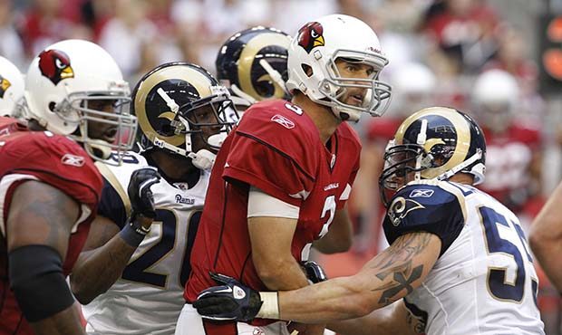 Arizona Cardinals' Derek Anderson (3) gets off a pass as St. Louis Rams' James Laurinaitis (55) and...