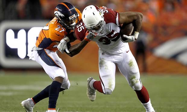 Arizona Cardinals Elijhaa Penny (35) is hit by Denver Broncos cornerback Brendan Langley (27) durin...