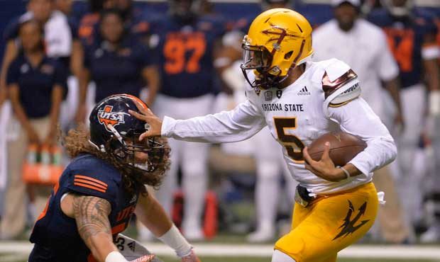 Arizona State quarterback Manny Wilkins (5) pushes off against UTSA linebacker Josiah Tauaefa durin...