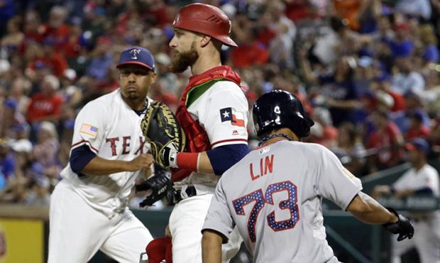 Boston Red Sox's Tzu-Wei Lin (73) scores on a single by Andrew Benintendi as Texas Rangers' Jonatha...