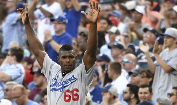 Los Angeles Dodgers outfielder Yasiel Puig, left, and relief pitcher Brandon Morrow celebrate in th...