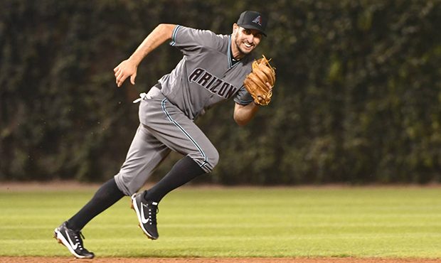 Arizona Diamondbacks' shortstop Adam Rosales chases a ball during the fifth inning of a baseball ga...