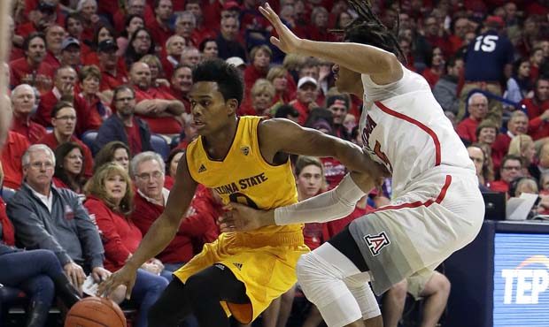 Arizona State guard Tra Holder (0) shields Arizona forward Keanu Pinder from the ball during the fi...