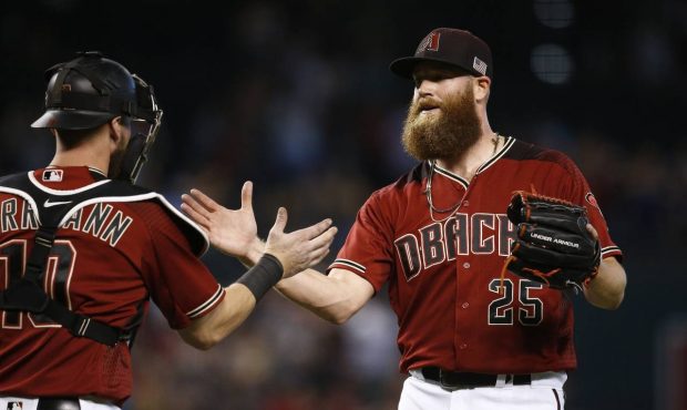 Arizona Diamondbacks' Archie Bradley (25) slaps hands with catcher Chris Hermann, left, after the f...