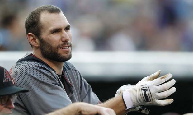 Arizona Diamondbacks' Paul Goldschmidt adjusts his batting gloves as he leans over the dugout rail ...