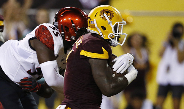 Arizona State's Kalen Ballage, right, scores a touchdown as he beats San Diego State's Chibu Onyeuk...