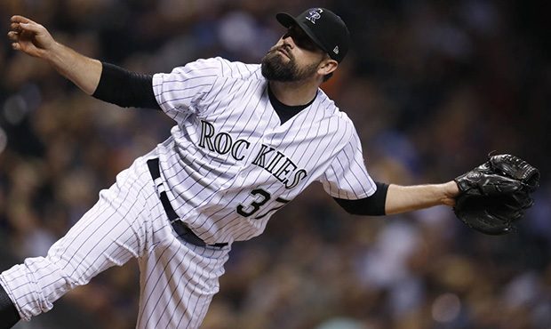 Colorado Rockies reliever Pat Neshek watches a pitch to Arizona Diamondbacks' J.D. Martinez during ...