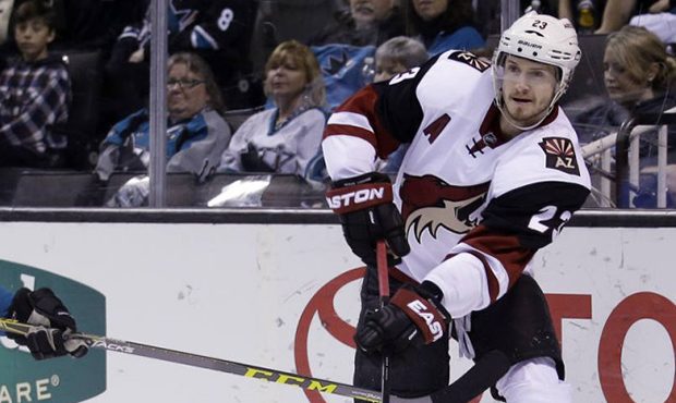 Arizona Coyotes defenseman Oliver Ekman-Larsson (23) works against San Jose Sharks' Chris Tierney (...