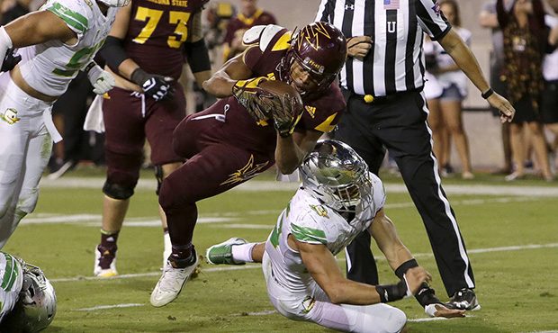 Arizona State running back Demario Richard (4) scores a touchdown over Oregon linebacker Troy Dye d...