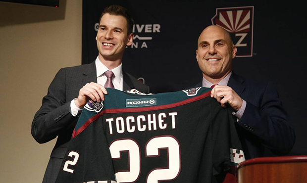 John Chayka, left, president of hockey operations for the Arizona Coyotes, poses for a photograph w...