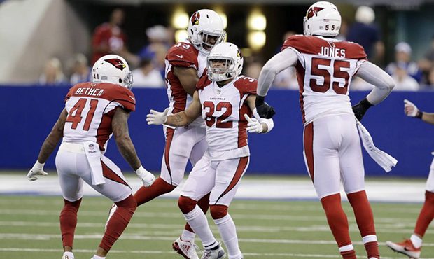 Arizona Cardinals' Tyrann Mathieu (32) celebrates with teammates after an interception during overt...