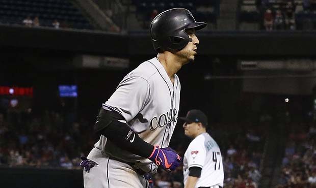 Colorado Rockies' Carlos Gonzalez, left, rounds the bases after hitting a two-run home run off Ariz...