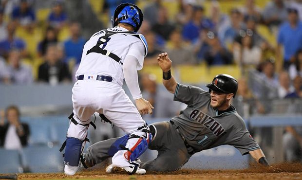 Arizona Diamondbacks' Chris Herrmann, right, scores on a fielder's choice hit by Brandon Drury afte...