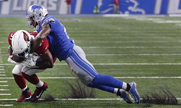 Detroit Lions free safety Glover Quin, right, tackles Arizona Cardinals running back David Johnson ...