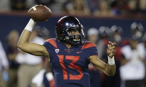 Arizona quarterback Brandon Dawkins throws against Utah during the first half of an NCAA college fo...