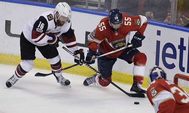 Arizona Coyotes left wing Max Domi (16) and Florida Panthers defenseman Jason Demers (55) fight for...