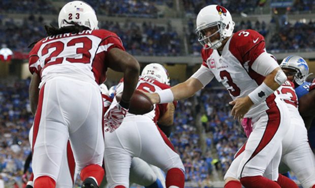 Arizona Cardinals quarterback Carson Palmer (3) hands the ball to running back Chris Johnson (23) d...