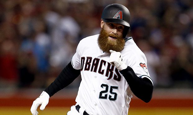 Arizona Diamondbacks' Archie Bradley rounds the bases on his two-run triple against the Colorado Ro...
