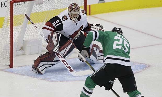 Arizona Coyotes goalie Adin Hill (31) defends the goal against Dallas Stars right wing Brett Ritchi...