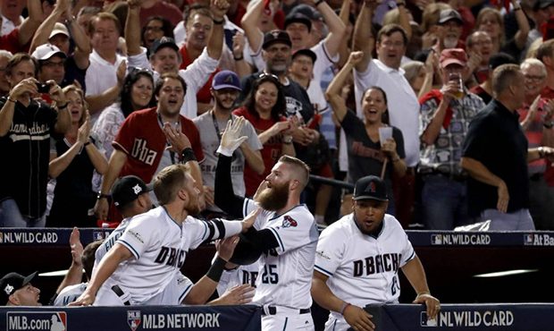 Arizona Diamondbacks' Archie Bradley (25) celebrate his two-run triple against the Colorado Rockies...