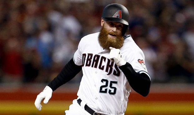 Arizona Diamondbacks' Archie Bradley rounds the bases on his two-run triple against the Colorado Ro...