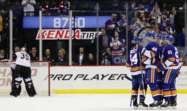 New York Islanders' John Tavares (91), Scott Mayfield (42) and Thomas Hickey (14) celebrate a goal ...