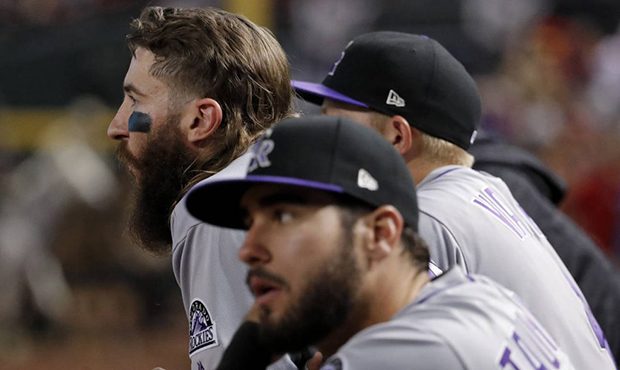 Colorado Rockies center fielder Charlie Blackmon, left, watches the Arizona Diamondbacks celebrate ...